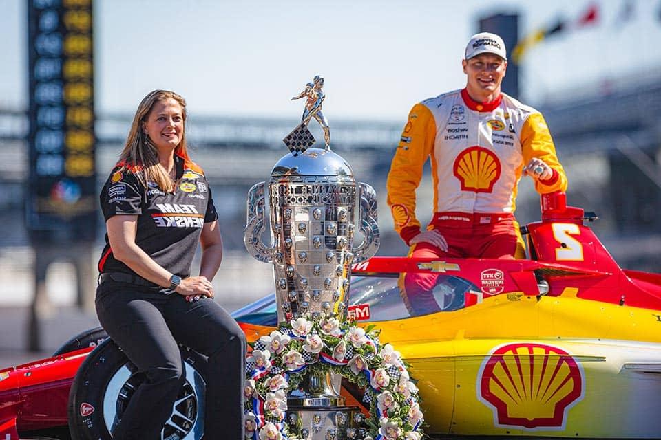 Lauren Sullivan poses with the winning car and trophy from the Indy 500